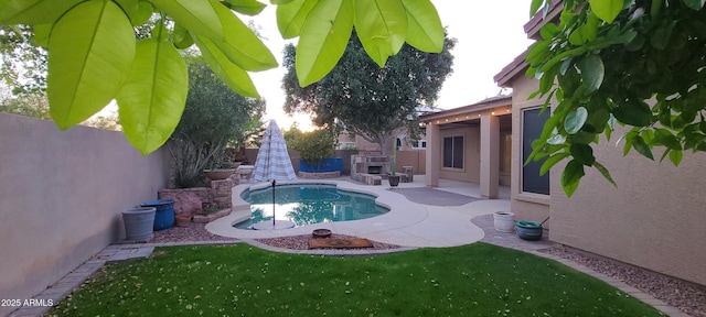 view of swimming pool featuring a yard, a fenced backyard, a fenced in pool, and a patio