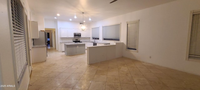 kitchen featuring a center island, light countertops, appliances with stainless steel finishes, white cabinetry, and recessed lighting