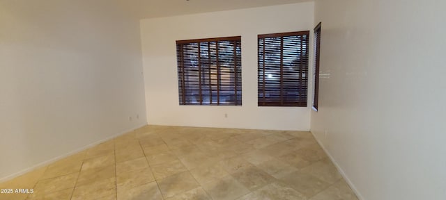 tiled spare room with baseboards