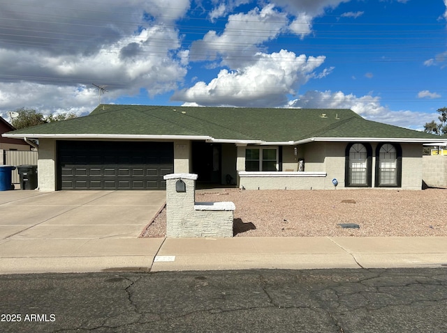 ranch-style house with a garage, driveway, and stucco siding