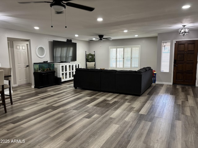 living room featuring recessed lighting, a ceiling fan, and wood finished floors