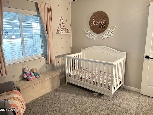 carpeted bedroom with a nursery area and baseboards