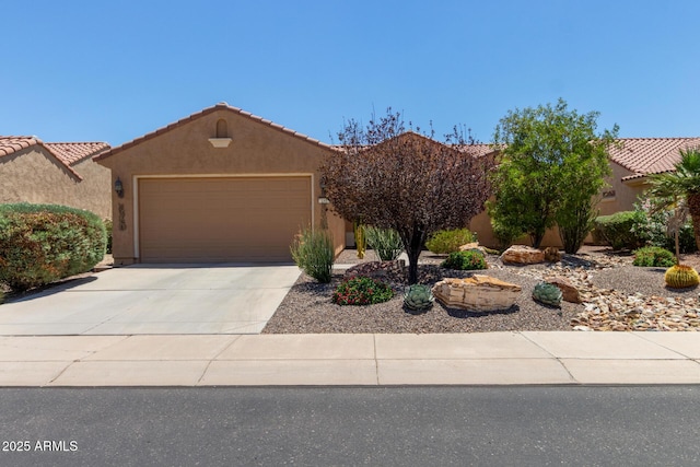 21893 N 261st Ave N, Buckeye, AZ 85396 - view of front of property featuring an attached garage, concrete driveway, stucco siding, and a tiled roof