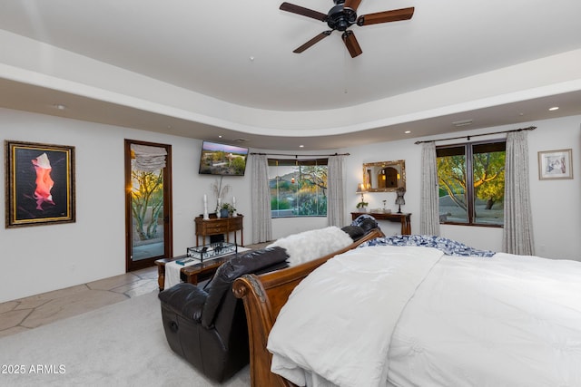 bedroom featuring access to exterior, multiple windows, and ceiling fan