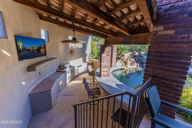 view of patio featuring a bar, area for grilling, and ceiling fan