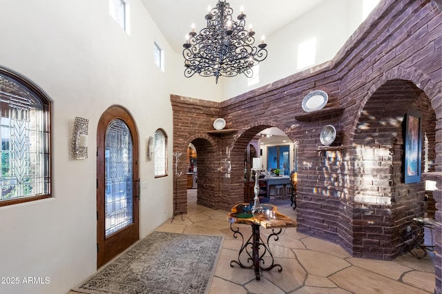 interior space with a chandelier and a towering ceiling