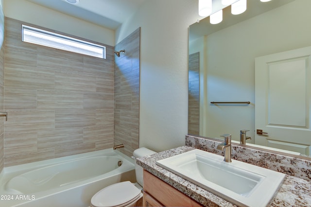 full bathroom with tiled shower / bath combo, vanity, and toilet