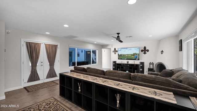 living room with wood-type flooring and ceiling fan