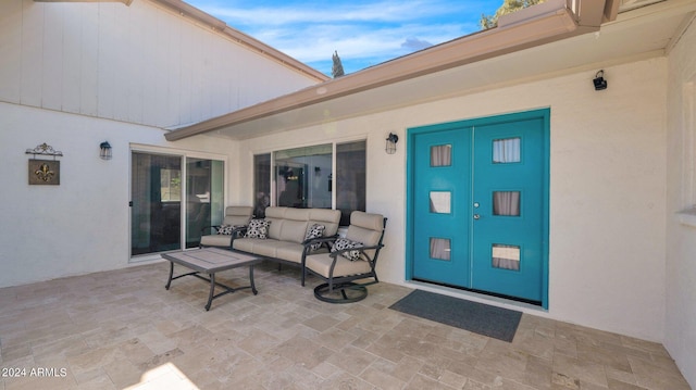 property entrance with outdoor lounge area and a patio area