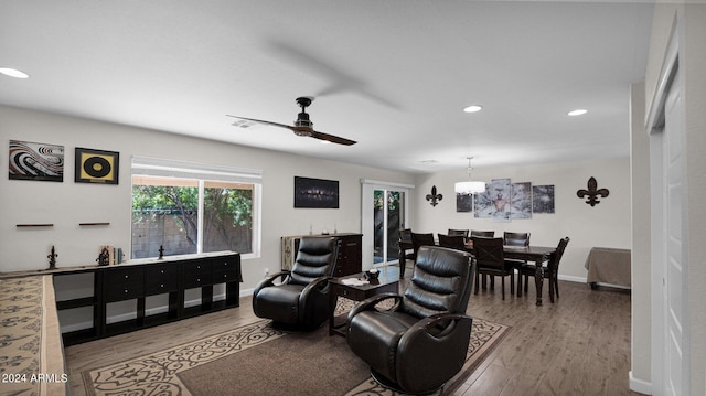 living room with light wood-type flooring and ceiling fan