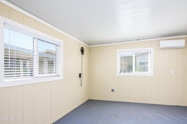 empty room featuring finished concrete flooring and a wall mounted air conditioner