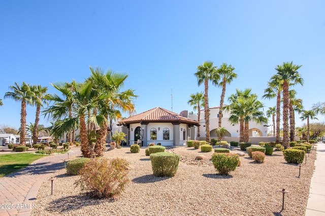 mediterranean / spanish-style home with a tile roof and stucco siding