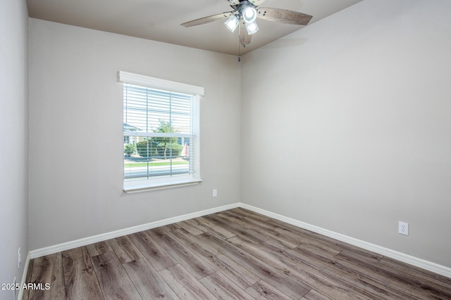 unfurnished room with ceiling fan, baseboards, and wood finished floors