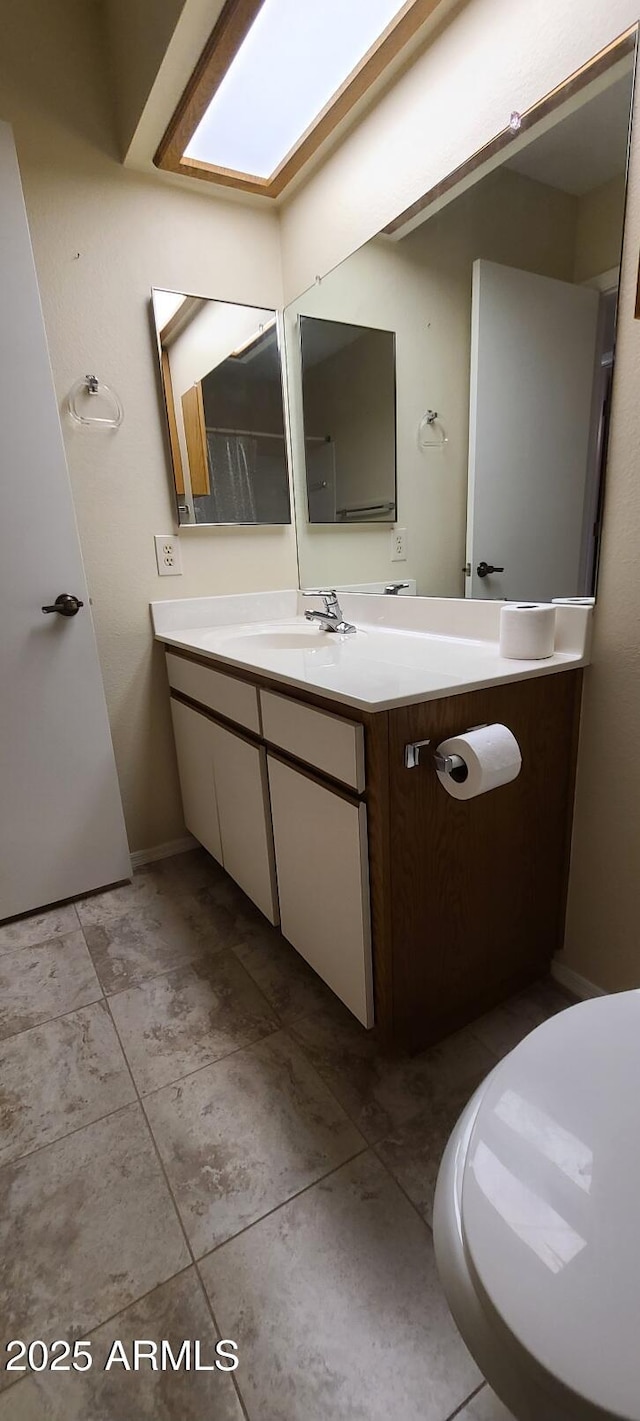 bathroom with tile patterned flooring and vanity