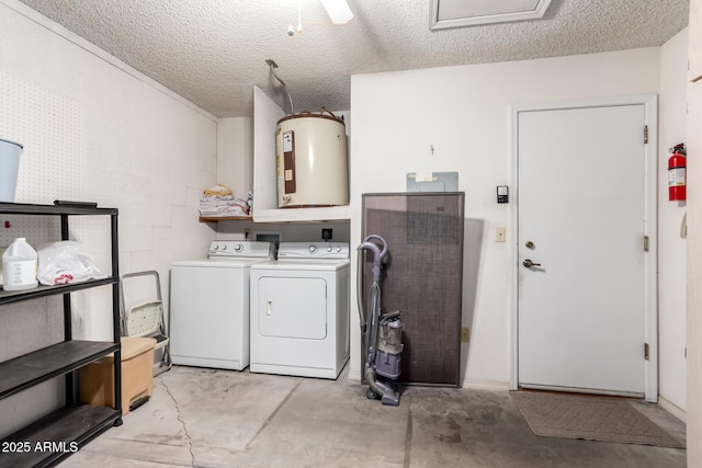 laundry room featuring electric water heater, a textured ceiling, laundry area, washer and dryer, and concrete block wall