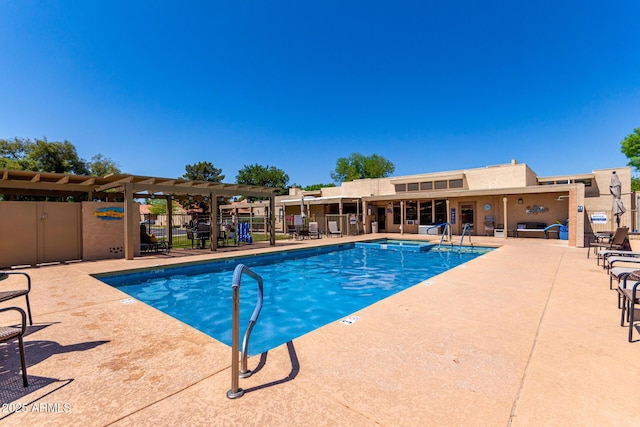 pool featuring a patio area, a community hot tub, and fence