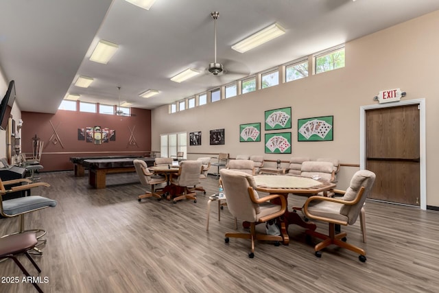 dining room with billiards, a high ceiling, a ceiling fan, and wood finished floors
