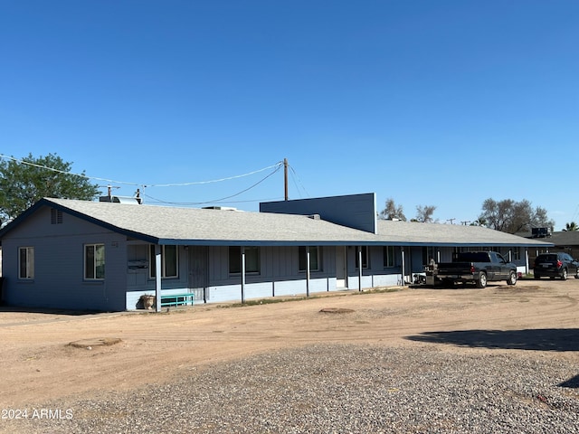 ranch-style house featuring a carport