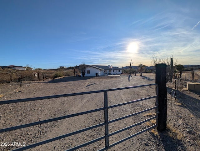 view of gate with a rural view