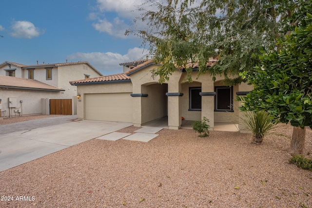 mediterranean / spanish-style home with a garage