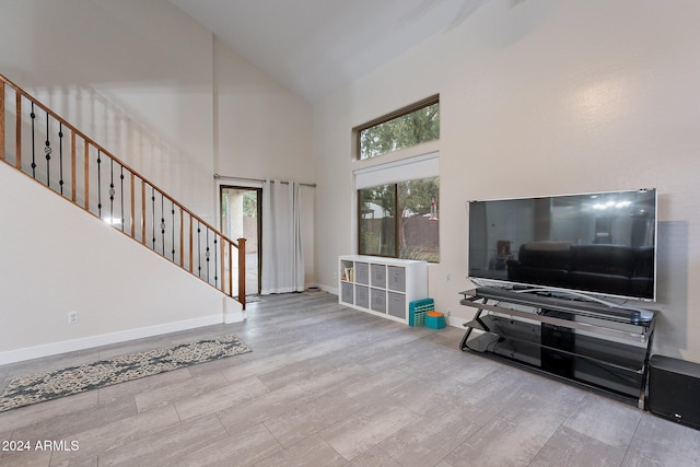 living room with high vaulted ceiling