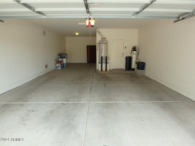 garage with a garage door opener and water heater