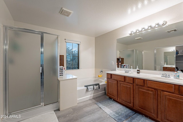 bathroom with plus walk in shower and vanity