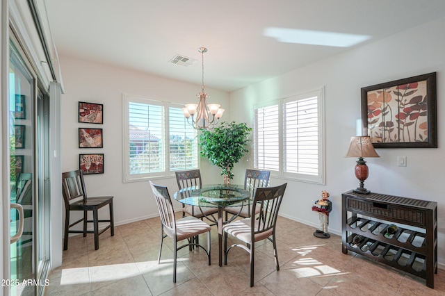 tiled dining area with a notable chandelier