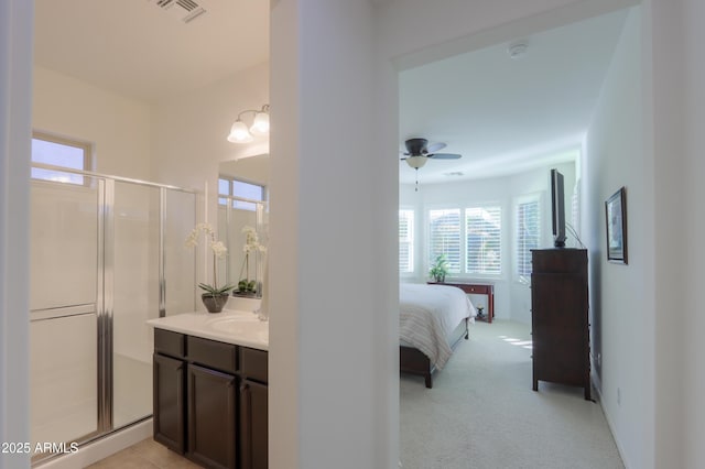 bathroom featuring vanity, ceiling fan, and an enclosed shower