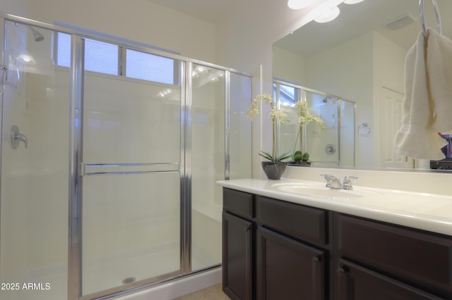 bathroom featuring an enclosed shower and vanity