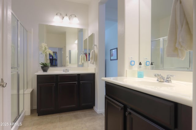 bathroom with tile patterned flooring, walk in shower, and vanity