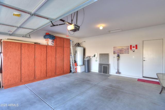 garage featuring a garage door opener and water heater