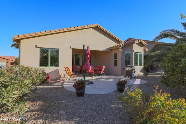 rear view of property featuring a patio