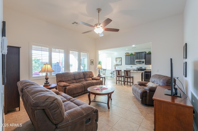 tiled living room featuring sink and ceiling fan