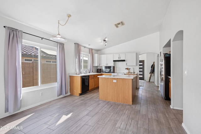 kitchen with white cabinetry, a center island, lofted ceiling, decorative light fixtures, and black appliances