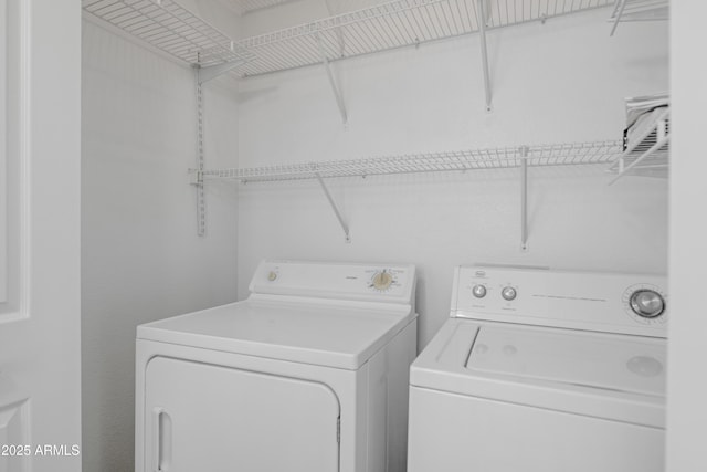 clothes washing area with washing machine and clothes dryer