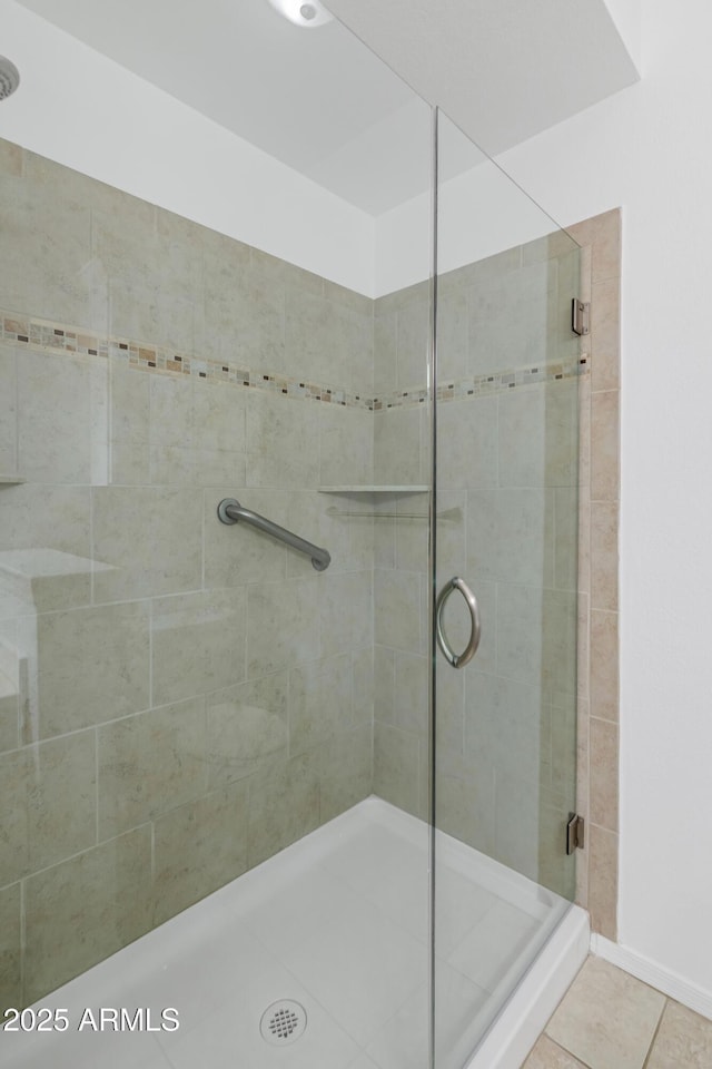 bathroom featuring walk in shower and tile patterned flooring