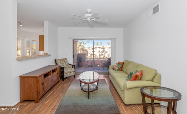 living room with ceiling fan and light hardwood / wood-style floors