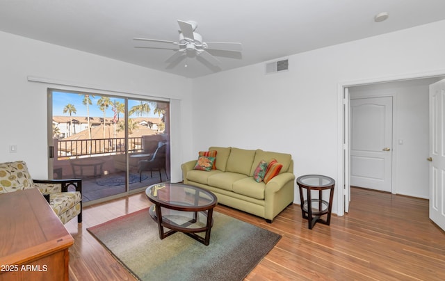 living room with ceiling fan and wood-type flooring