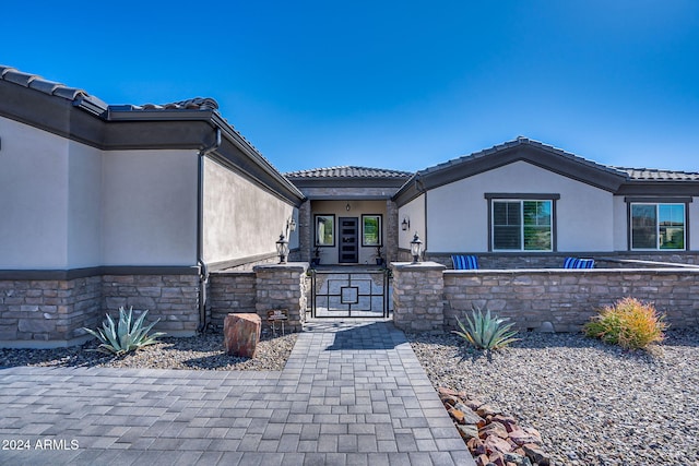8523 N 192nd Ave, Waddell, AZ 85355 - property entrance with stone siding, a gate, and stucco siding