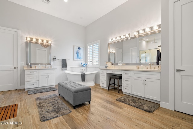 bathroom with a tub, vanity, and hardwood / wood-style flooring