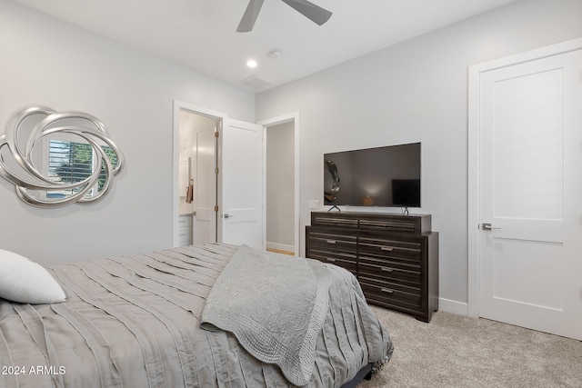 carpeted bedroom featuring ceiling fan and ensuite bathroom