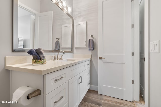 bathroom with hardwood / wood-style floors and vanity