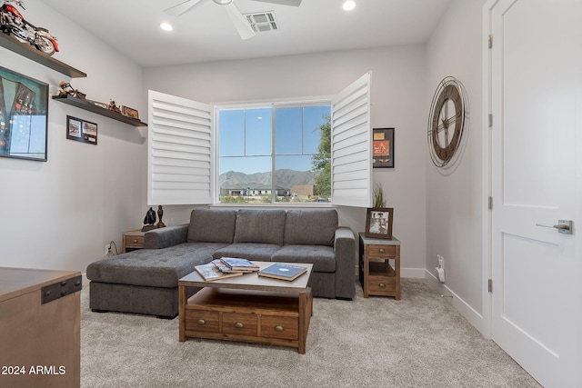 living room with ceiling fan and light colored carpet