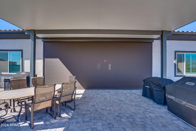 8523 N 192nd Ave, Waddell, AZ 85355 - view of patio with outdoor dining space, a garage, and area for grilling