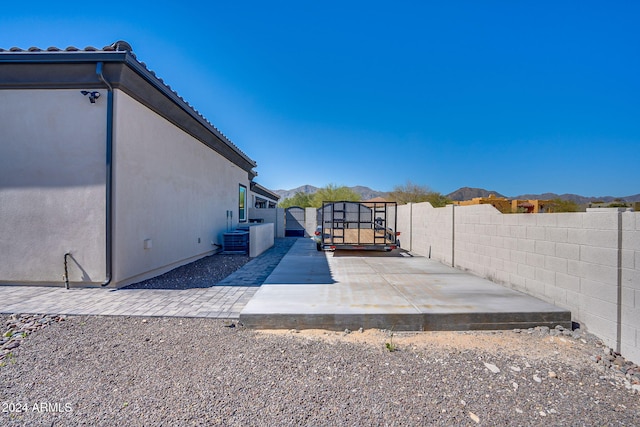 exterior space with central air condition unit, a patio area, and a mountain view