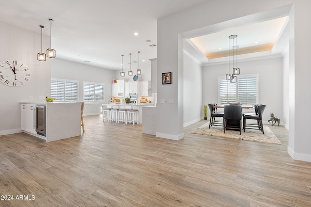 kitchen featuring a wealth of natural light, white cabinetry, and light hardwood / wood-style floors