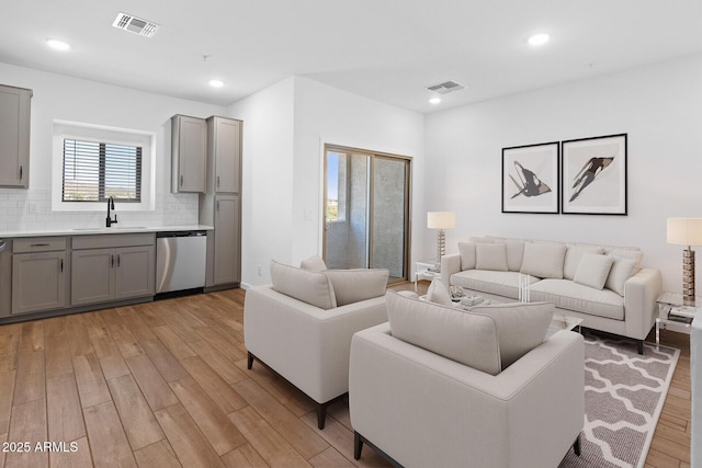 living room featuring sink and light wood-type flooring