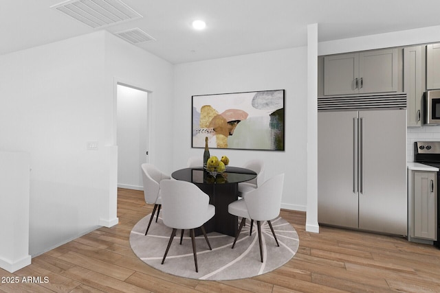 dining space with light wood-type flooring