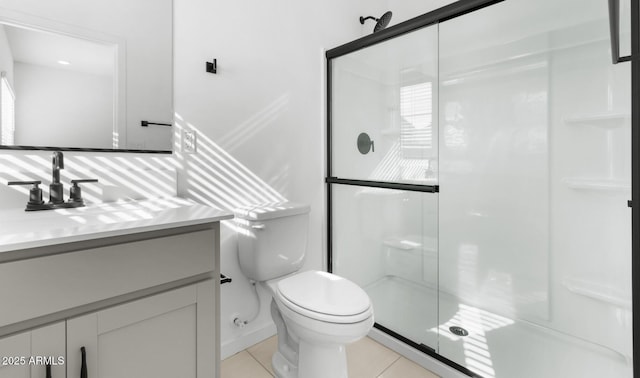 bathroom with vanity, toilet, tile patterned floors, and a shower with shower door